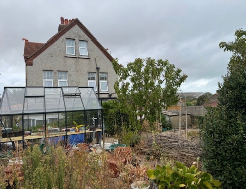 Lot: 87 - FREEHOLD DETACHED FORMER GUEST HOUSE ARRANGED AS FOUR FLATS ON GOOD SIZE PLOT WITH PARKING - View of the rear of the building from the garden